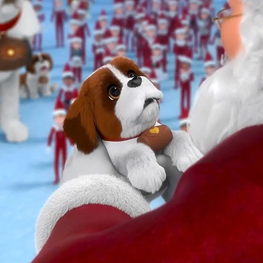 A view over Santa's left shoulder. In his hands lifted up to his chest is a St. Bernard pup. In the background are dozens of Scout Elves, another St. Bernard Pup and Barry standing on a large patch of snow.