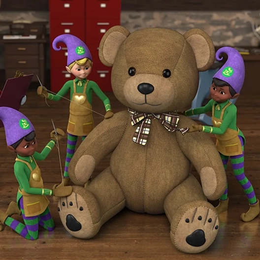 Three Toy Makers surrounding a large teddy bear. Two Elves are sewing the seams and the third is adjusting a bow around the teddy bear's neck.