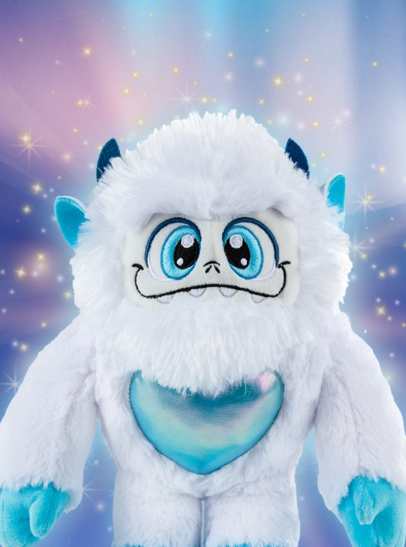 Little Grunt plush poses over a wintery, festive snowscape. He is surrounded by stars and light bursts.