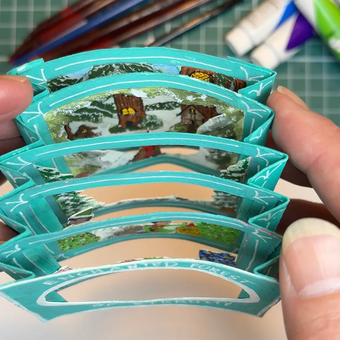 Image shows a tunnel book from top view, depicting each layer that makes up the scene