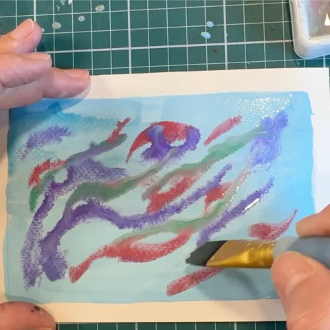 Painted back layer of tunnel book depicting northern lights