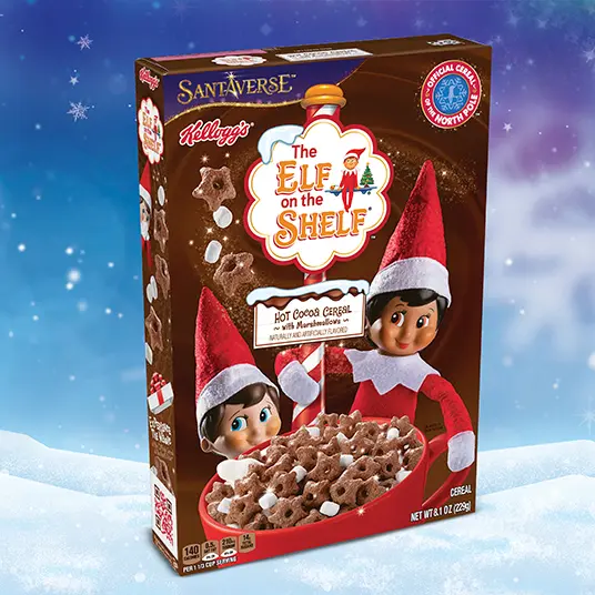 Box of Kellogg's, Santaverse, and The Elf on the Shelf branded Hot Cocoa Cereal on a snowy background.