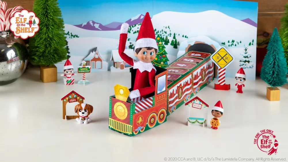 Elf Scout on a train with little scout elves around and a winter mountain backdrop.