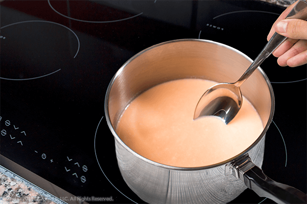 pot with cocao in it with spoon
