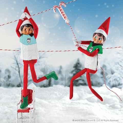 two scout elves on ziplines in winter outside