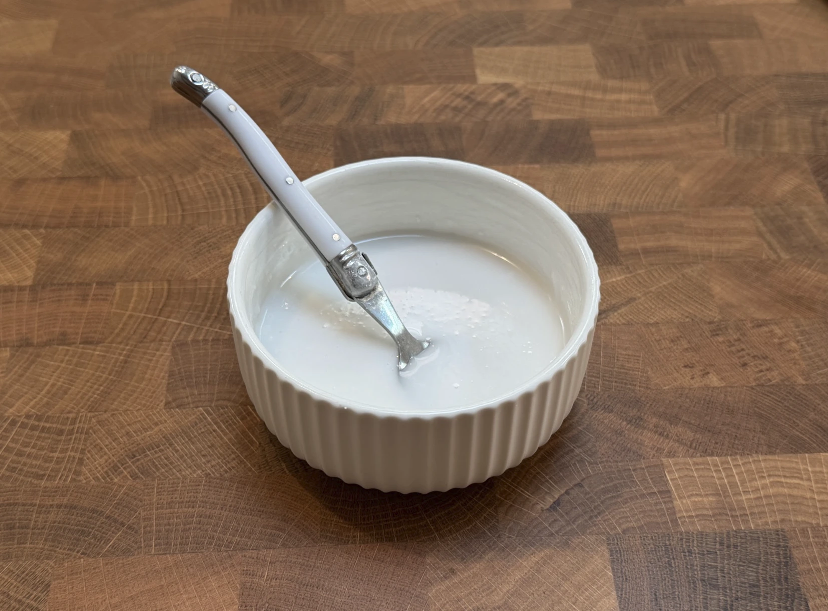 Icing being mixed in a small bowl