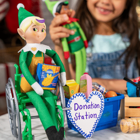 Two Elf Mates one in a wheelchair with a donation station.