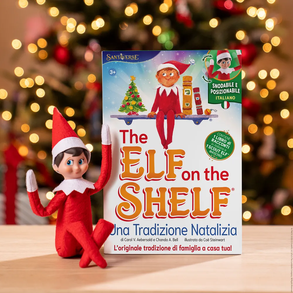 The Elf on the Shelf Scout Elf and keepsake box beside a Christmas tree