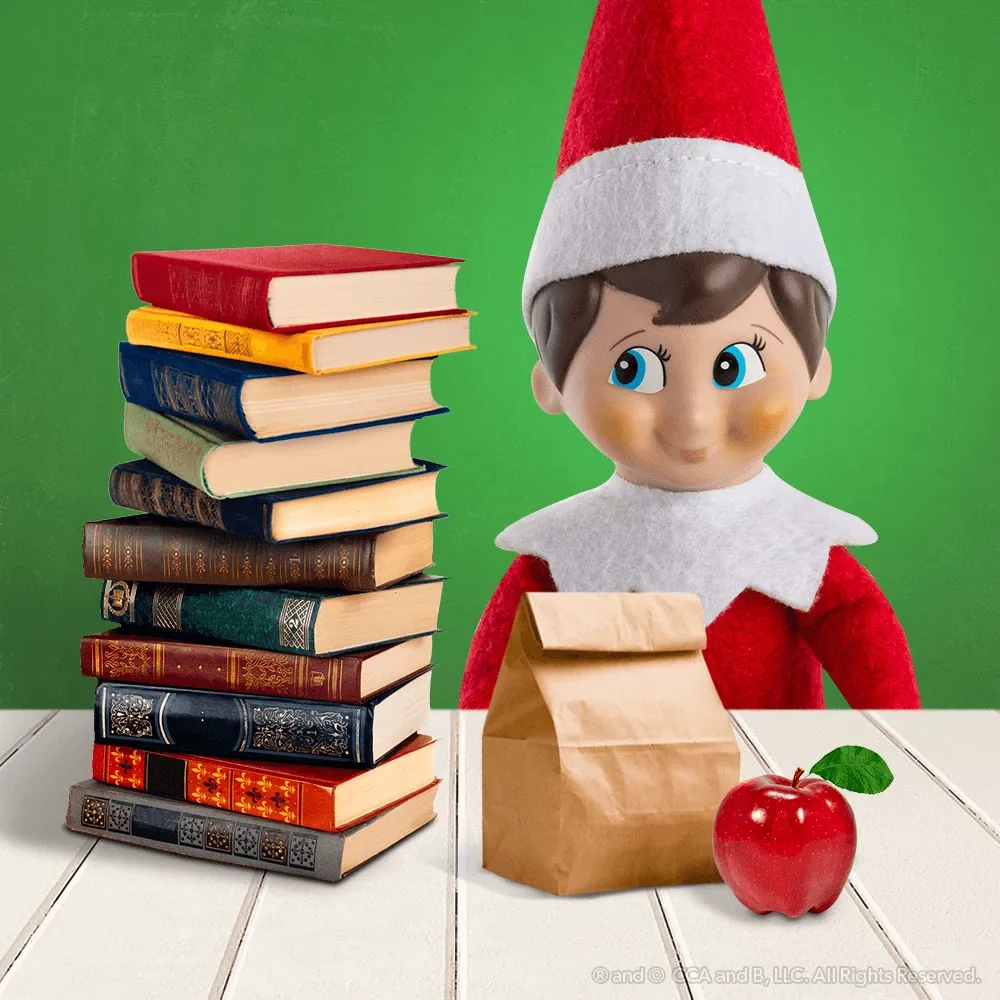A Scout Elf beside a tall stack of books, a brown paper lunch bag and a red apple